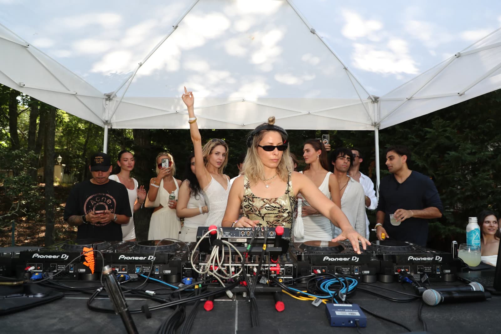 BLOND:SH performing under the tent as guests dance